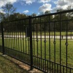 wrought iron fence on the side of the road