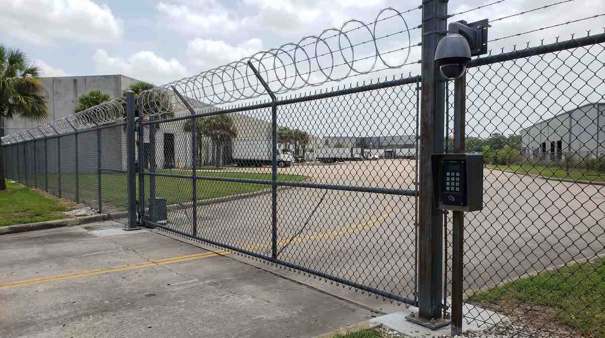 High-security chain link fence with camera and access control at a Houston Texas business