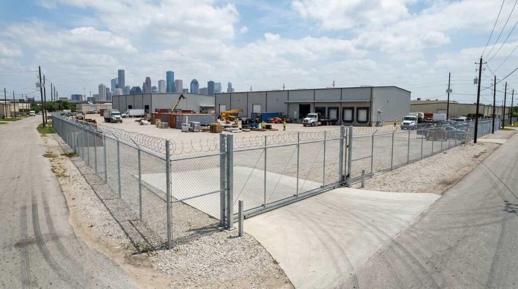 Commercial chain link fence with barbed wire around a Houston Texas industrial property