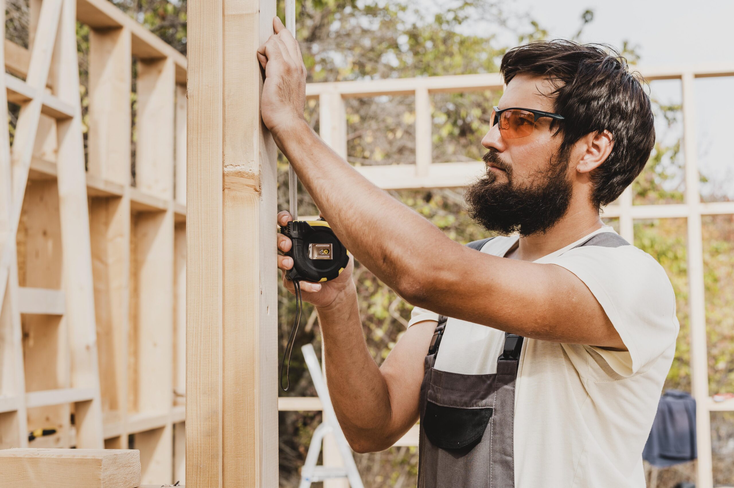 Carpenter Man Using Tape Measure - Griffin Fence Houston TX